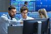 traders in front of computer
